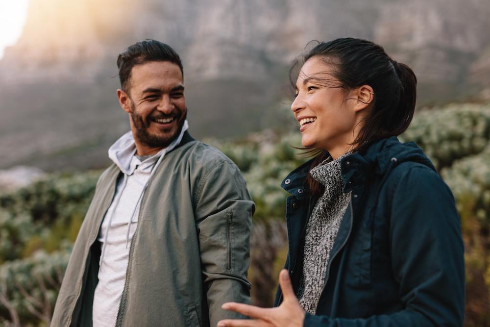 Two people walking outdoors together in conversation